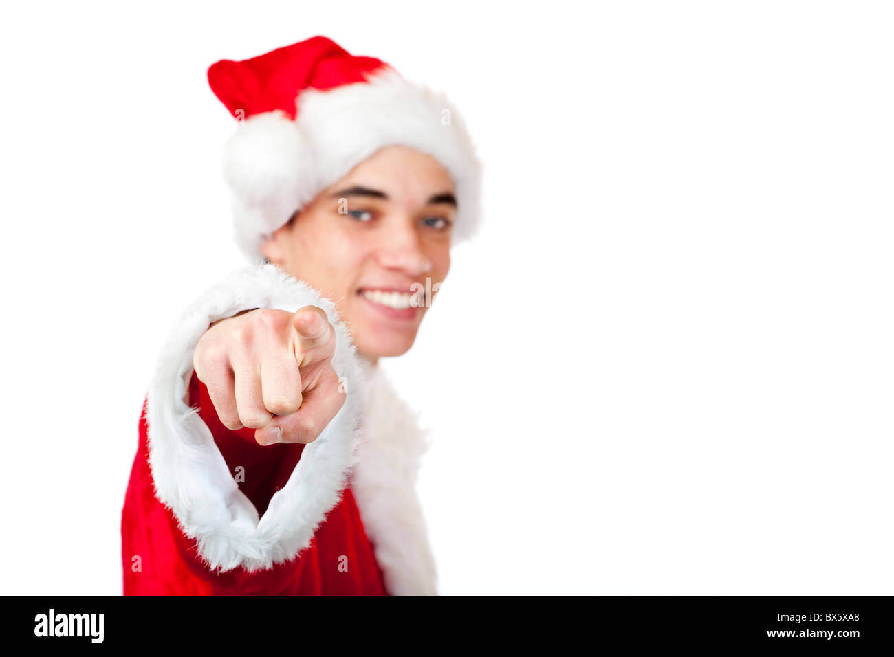 Smiling male Santa Claus teenager pointing at camera. Isolated on white background. Stock Photo