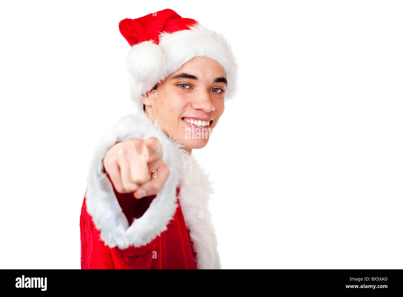 Smiling male Santa Claus teenager pointing at camera. Isolated on white background. Stock Photo
