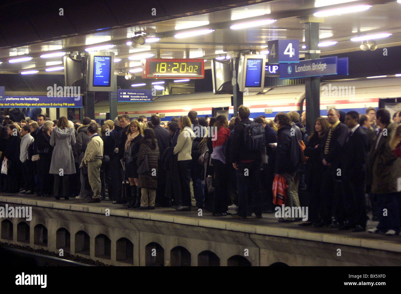crowded train platform at London Bridge with people waiting Stock Photo