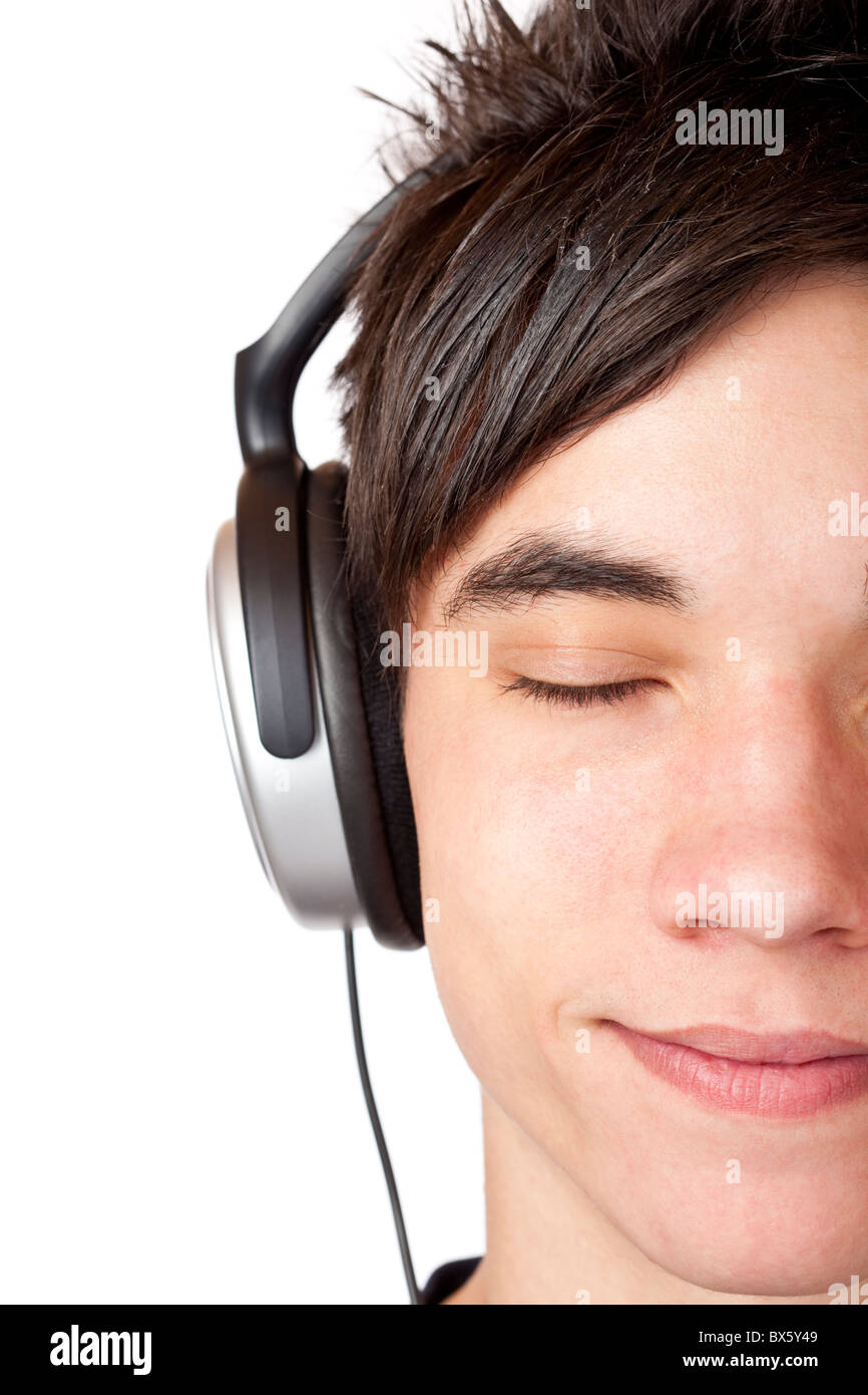 Close-up macro of a male teenager listening to music with headphone. Isolated on white. Stock Photo