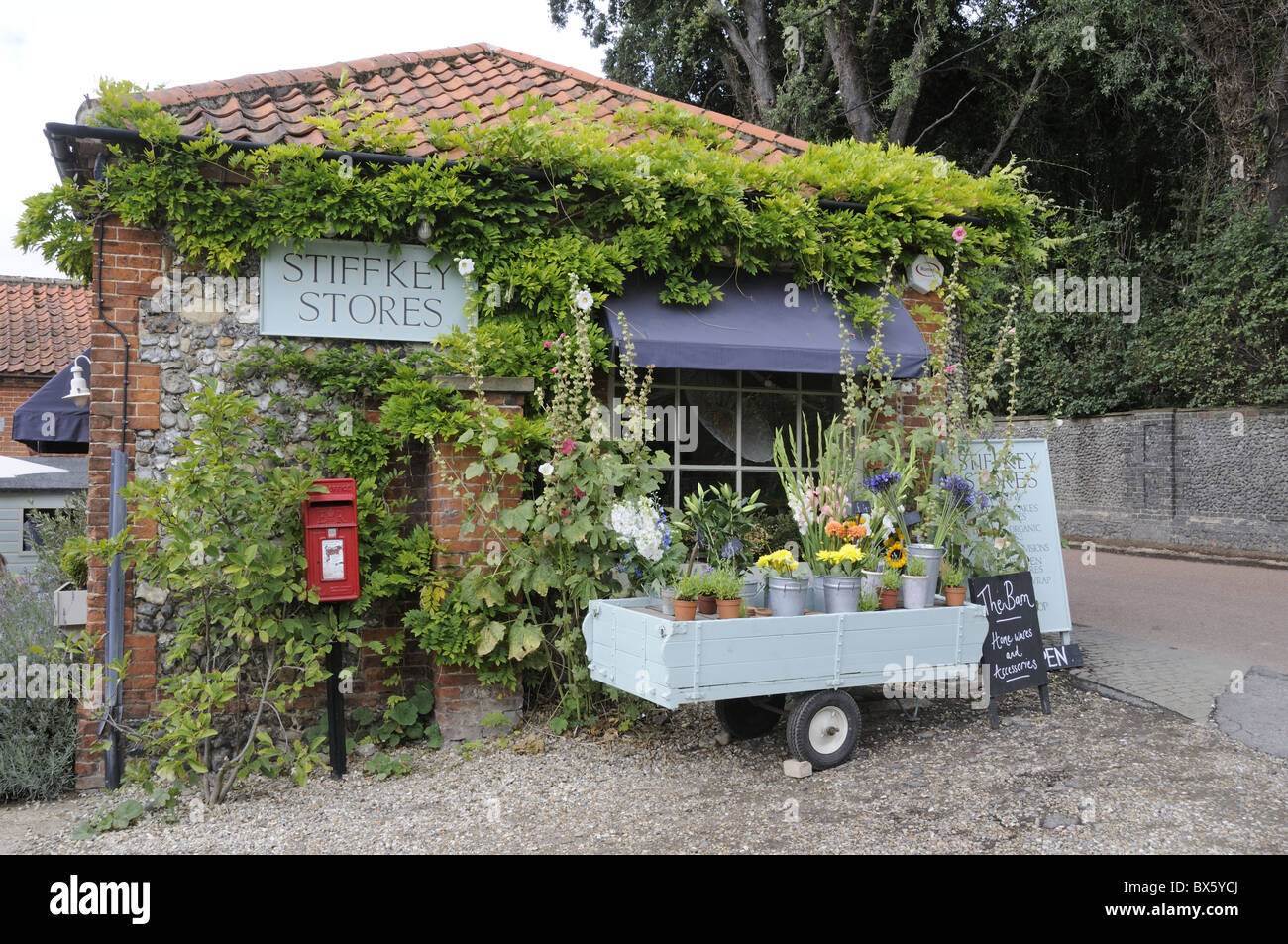 Village stores and post office with flowers for sale outside, Stiffkey, Norfolk, Uk, August Stock Photo