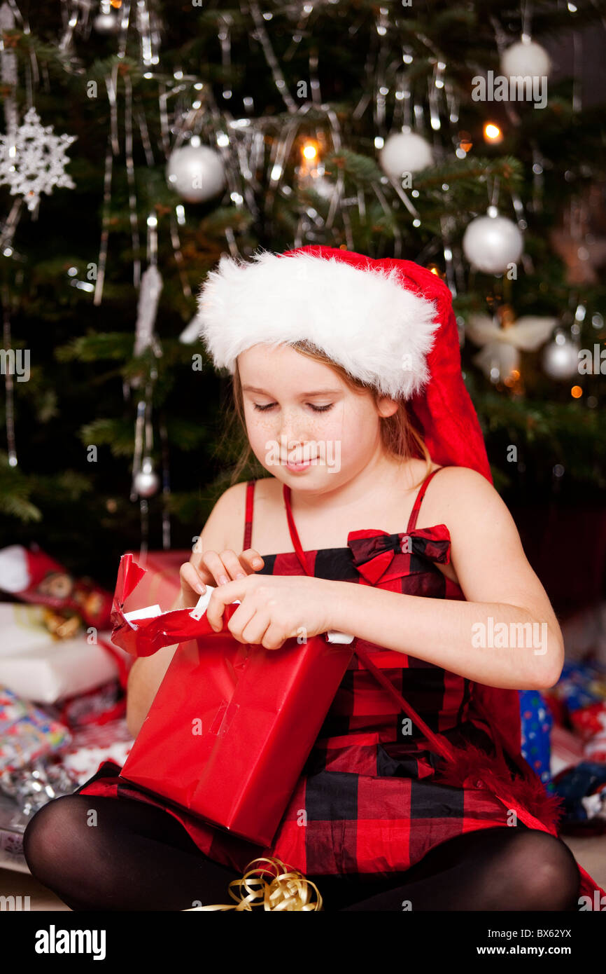Girl unwrap a Christmas gift.Sweden Stock Photo