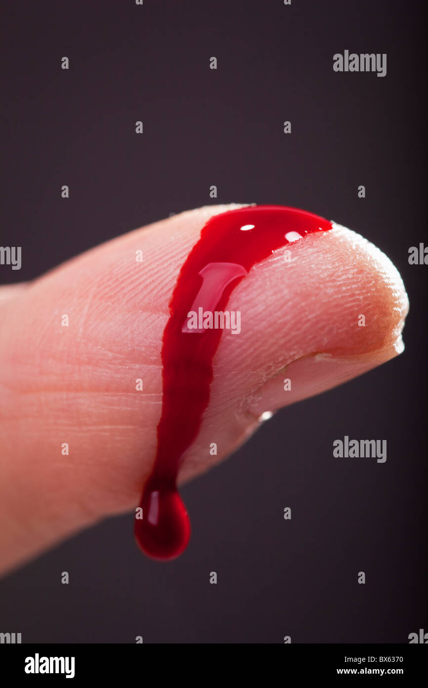 Drop of blood run on a fingertip.Sweden Stock Photo