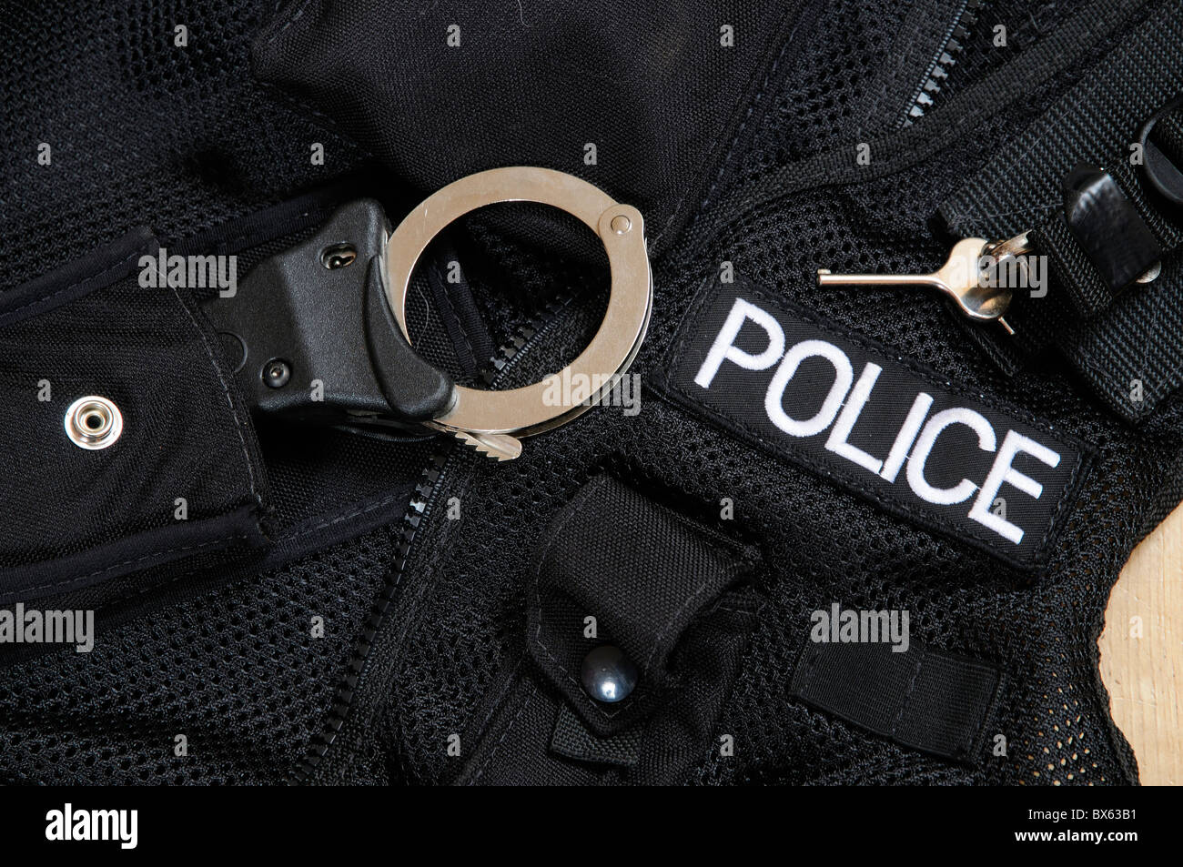Police handcuffs and unlocking key Stock Photo