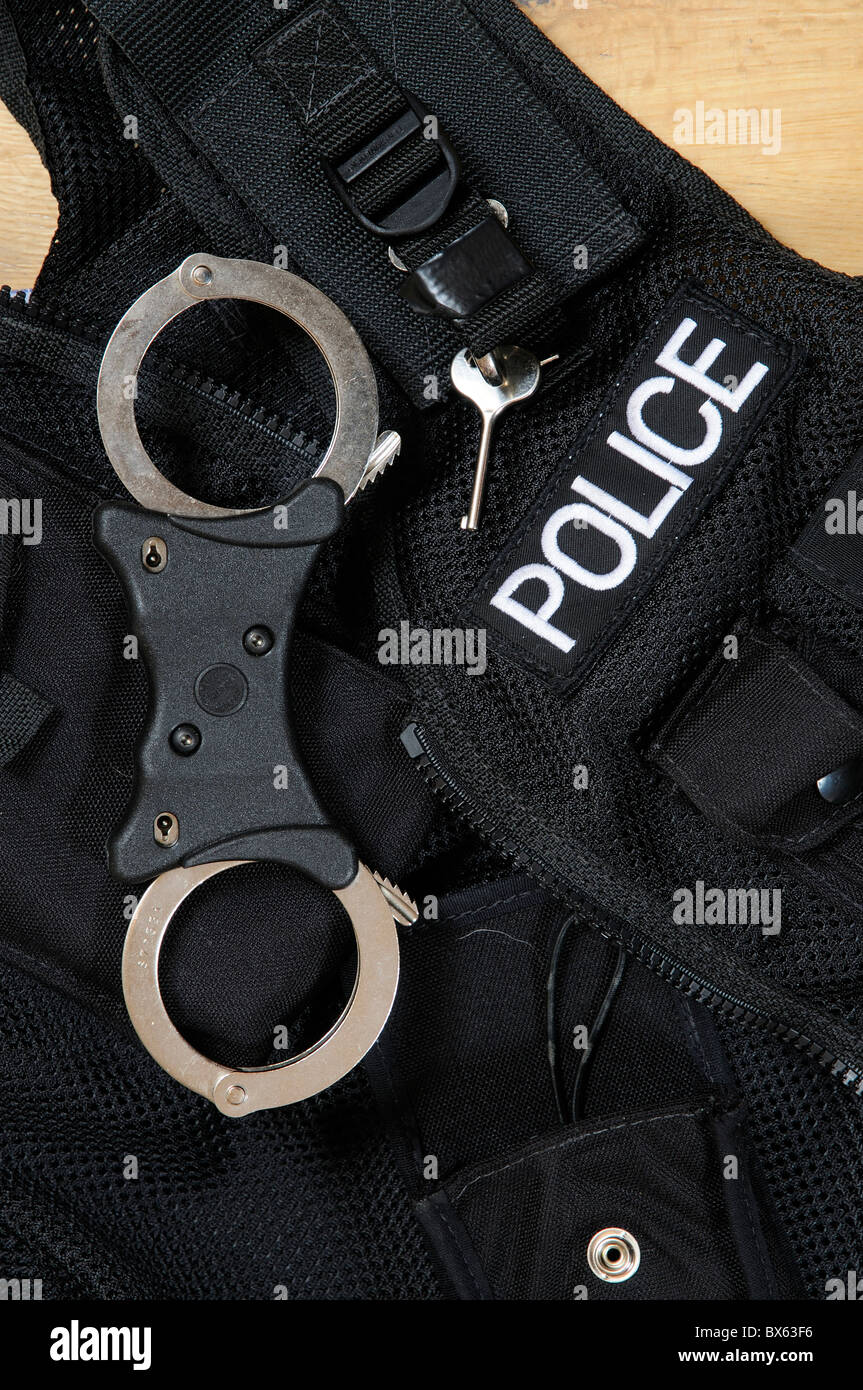 Police handcuffs and unlocking key Stock Photo