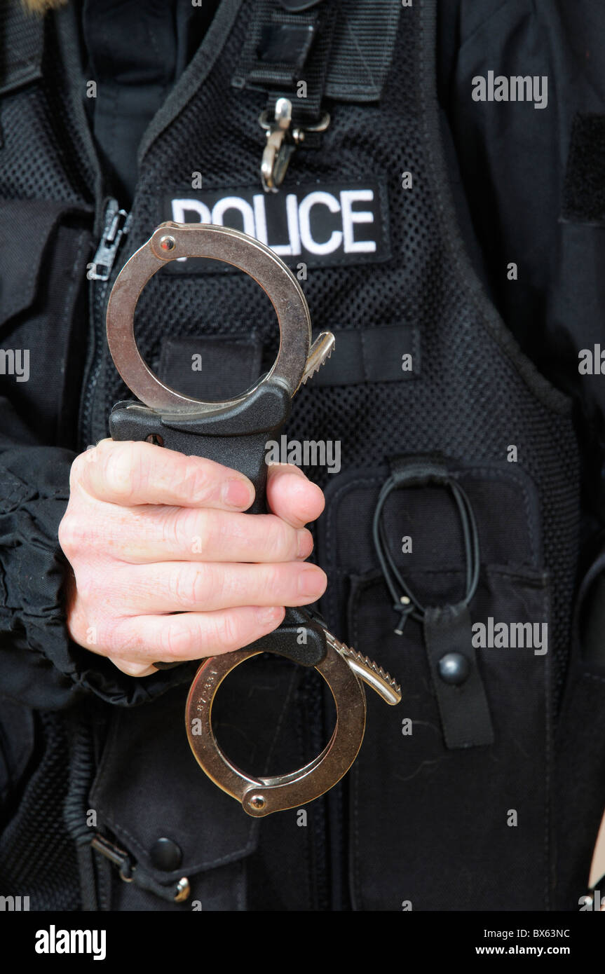Police officer holding handcuffs Stock Photo