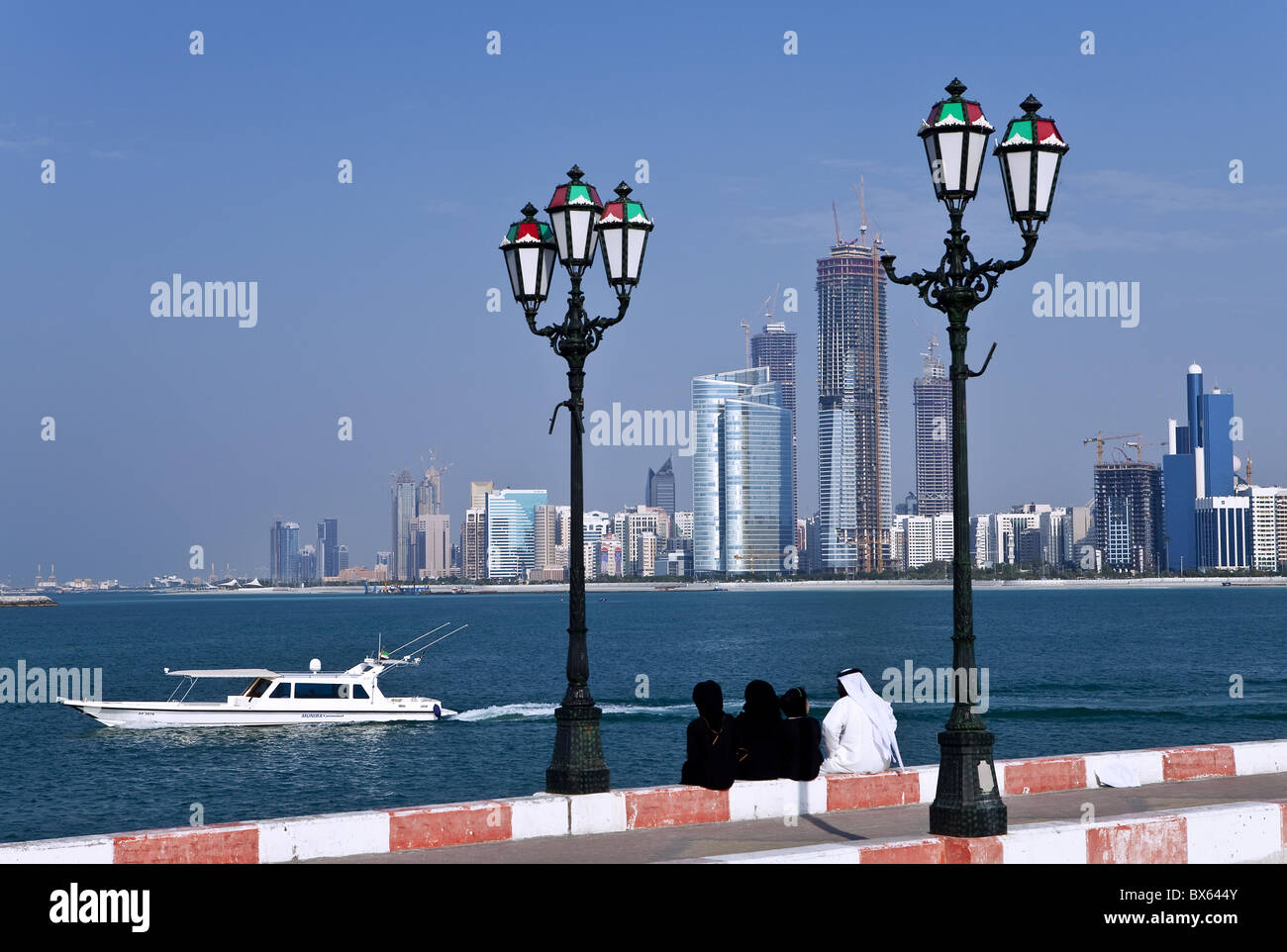 City skyline and the famous Corniche looking across the harbour from a pier, Abu Dhabi, United Arab Emirates, Middle East Stock Photo