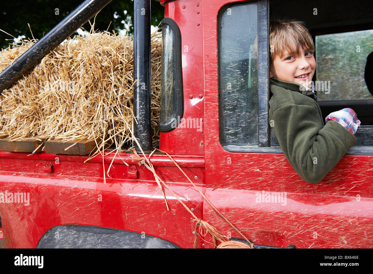 Young boy smiling in the back of 4x4 Stock Photo