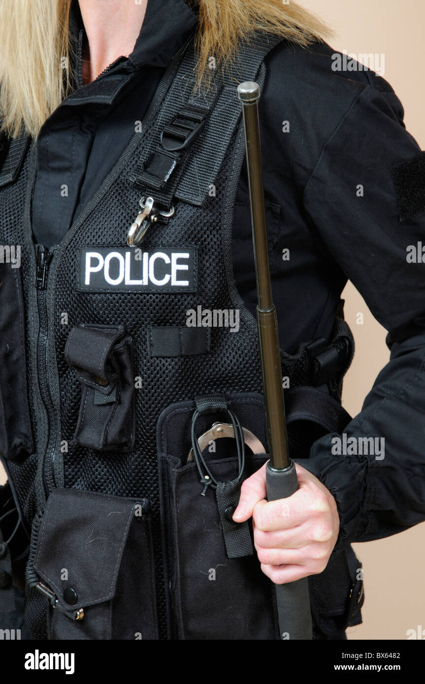 Police officer holding a telescopic baton Stock Photo - Alamy