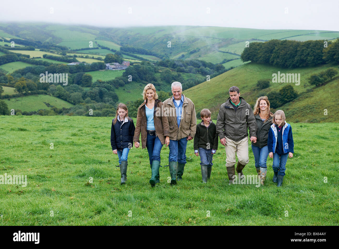 Generational family walking in fields Stock Photo