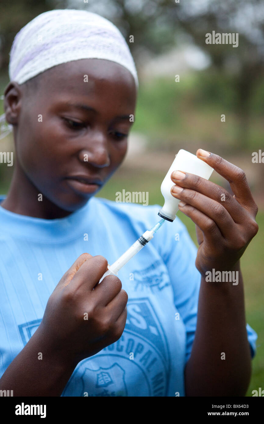 A woman draws medicine from a bottle in Kakata, Liberia, West Africa. Stock Photo