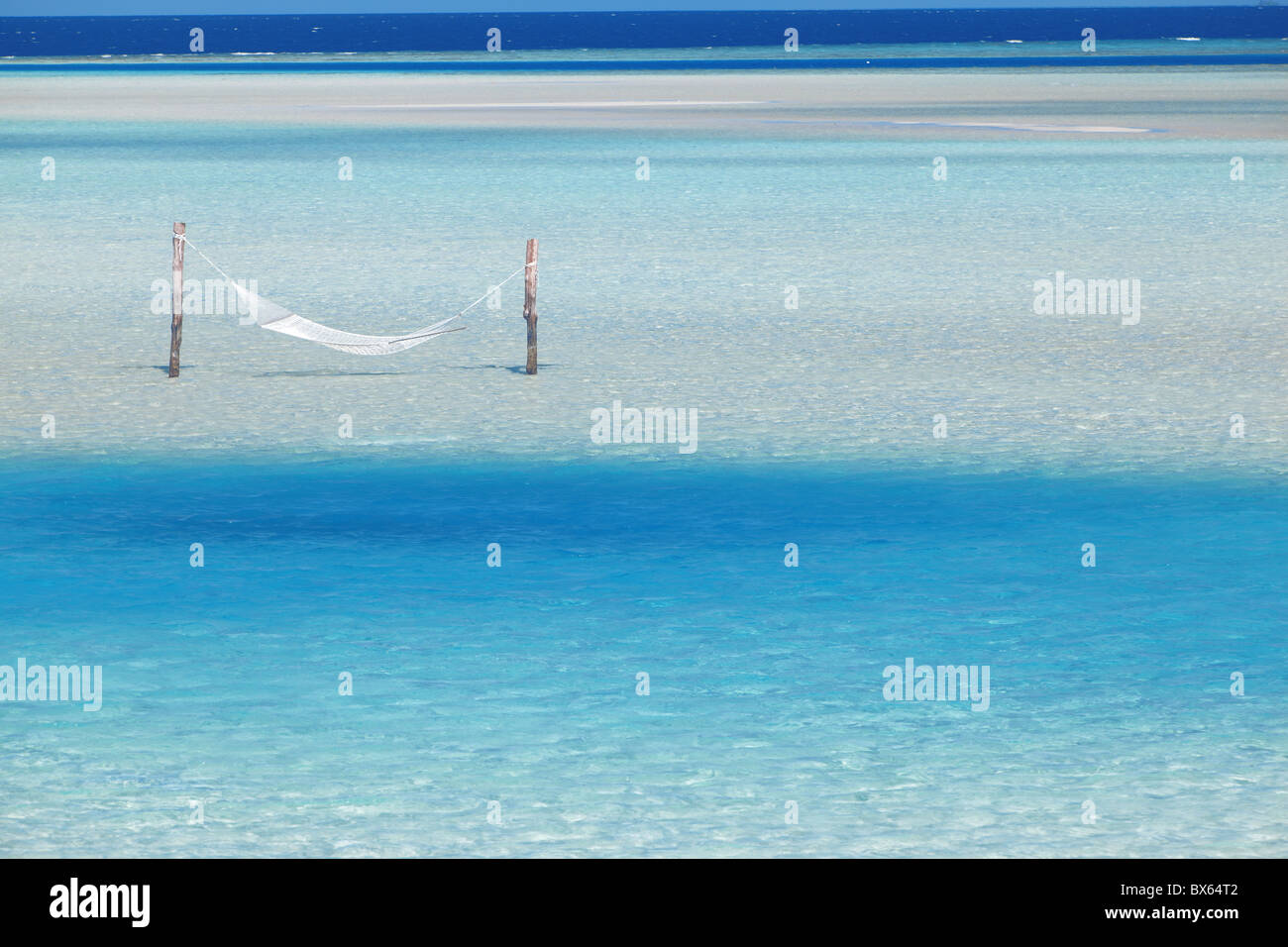 Hammock hanging in shallow clear water, Maldives, Indian Ocean, Asia Stock Photo