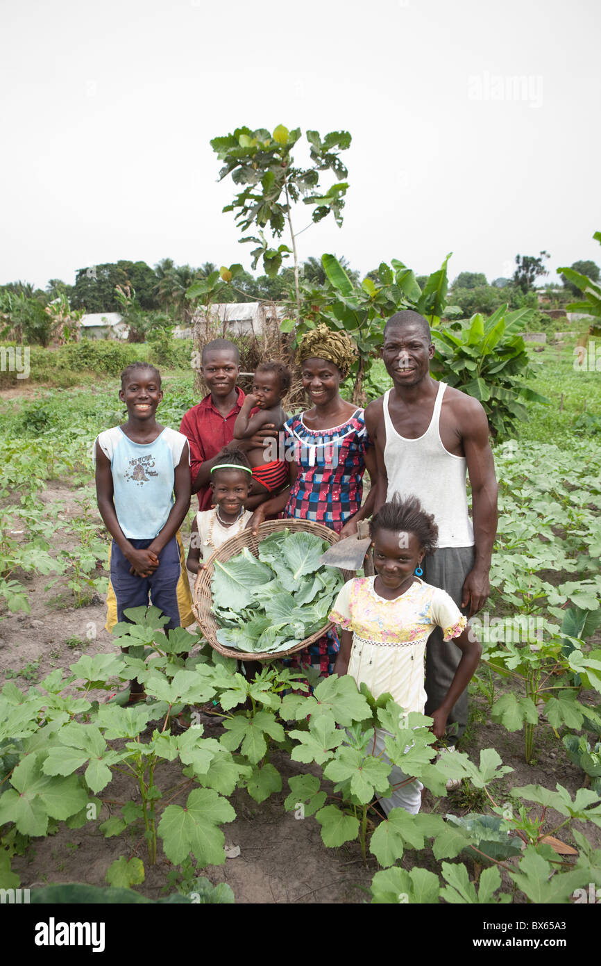 A family poses in their vegetable garden in Kakata, Liberia, West Africa. Stock Photo