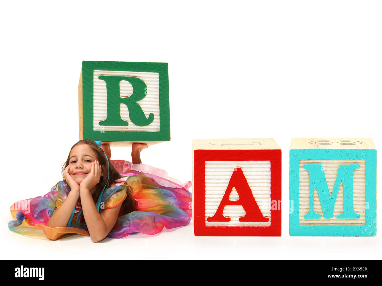 Beautiful six year old girl spelling word RAM with giant alphabet ...