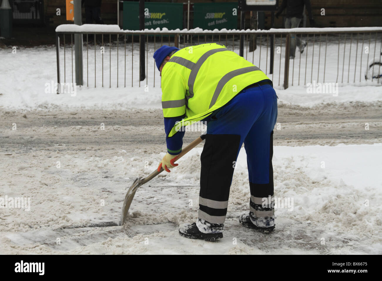 A council worker clears the streets of snow at Eastbourne, East Sussex, England. Stock Photo
