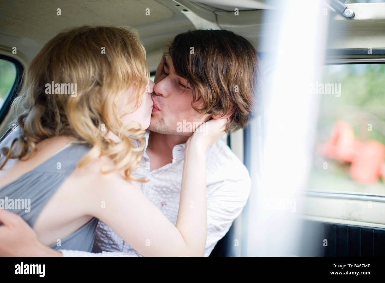 Lovers kissing in the car Stock Photo