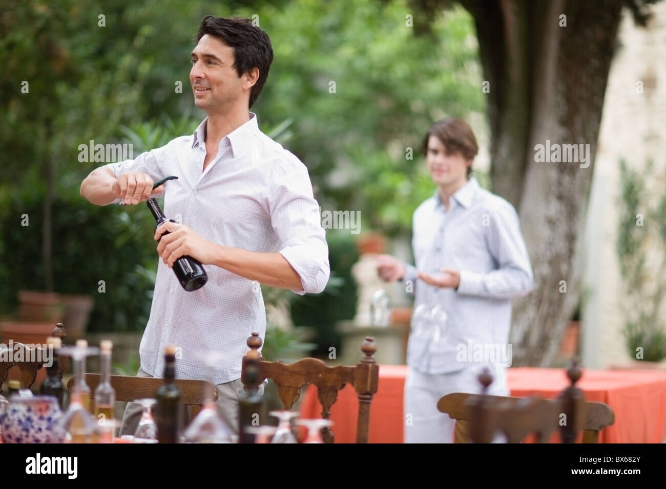 Two men preparing the table Stock Photo - Alamy