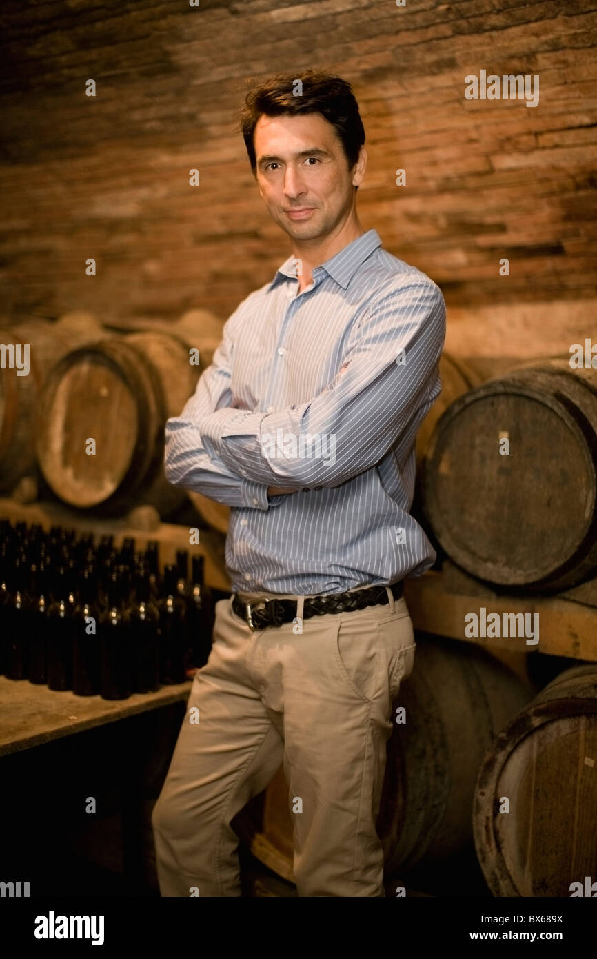 Man standing in wine cellar Stock Photo - Alamy