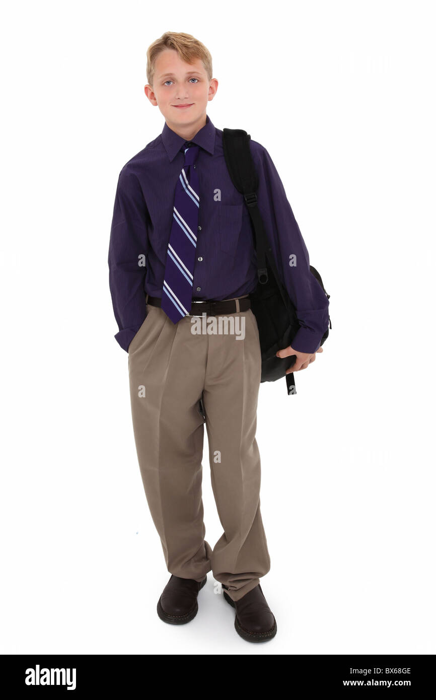 Attractive 12 year old boy in dress shirt and tie with backpack over white background. Stock Photo
