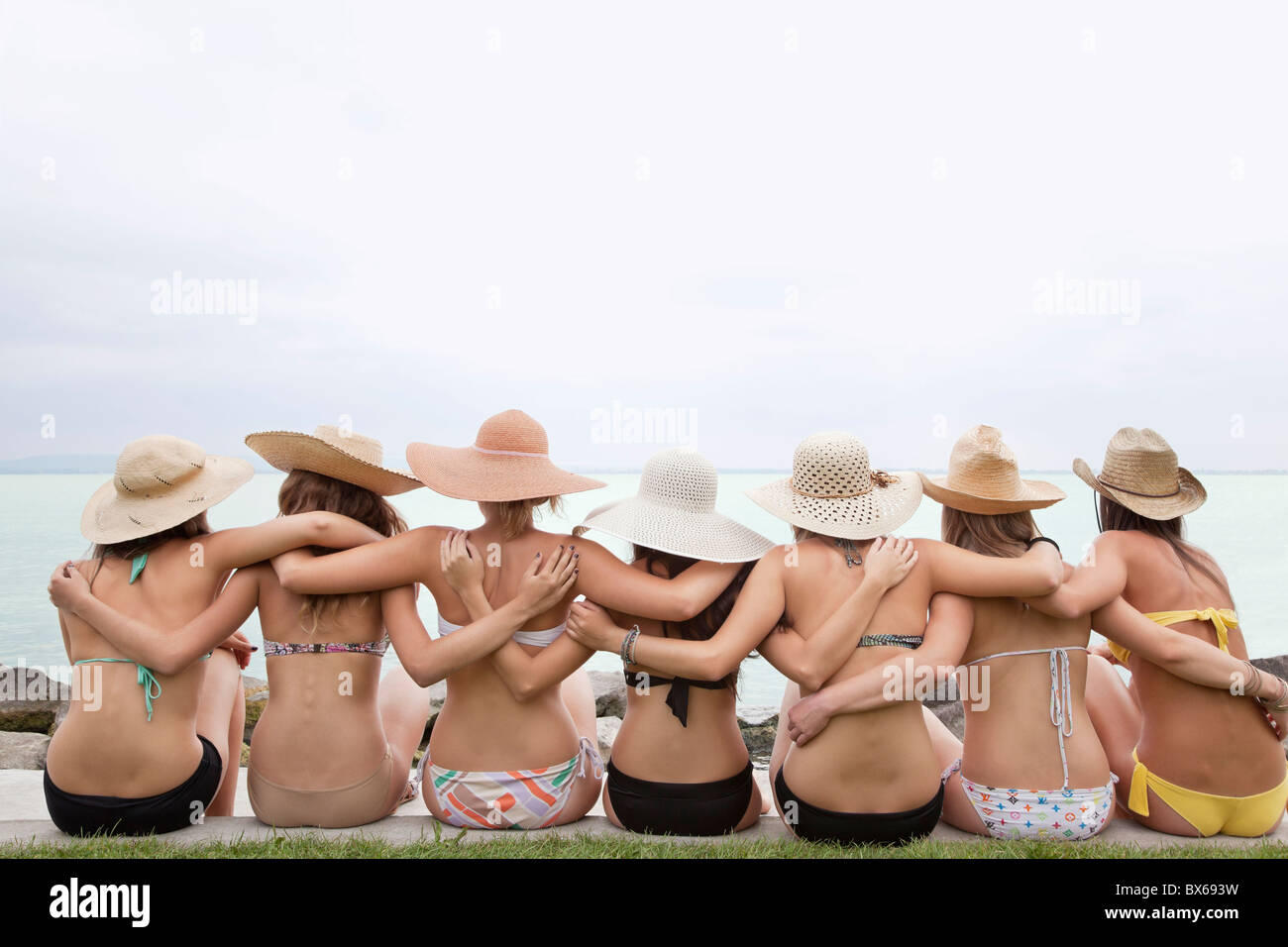 Women in bikinis hugging Stock Photo