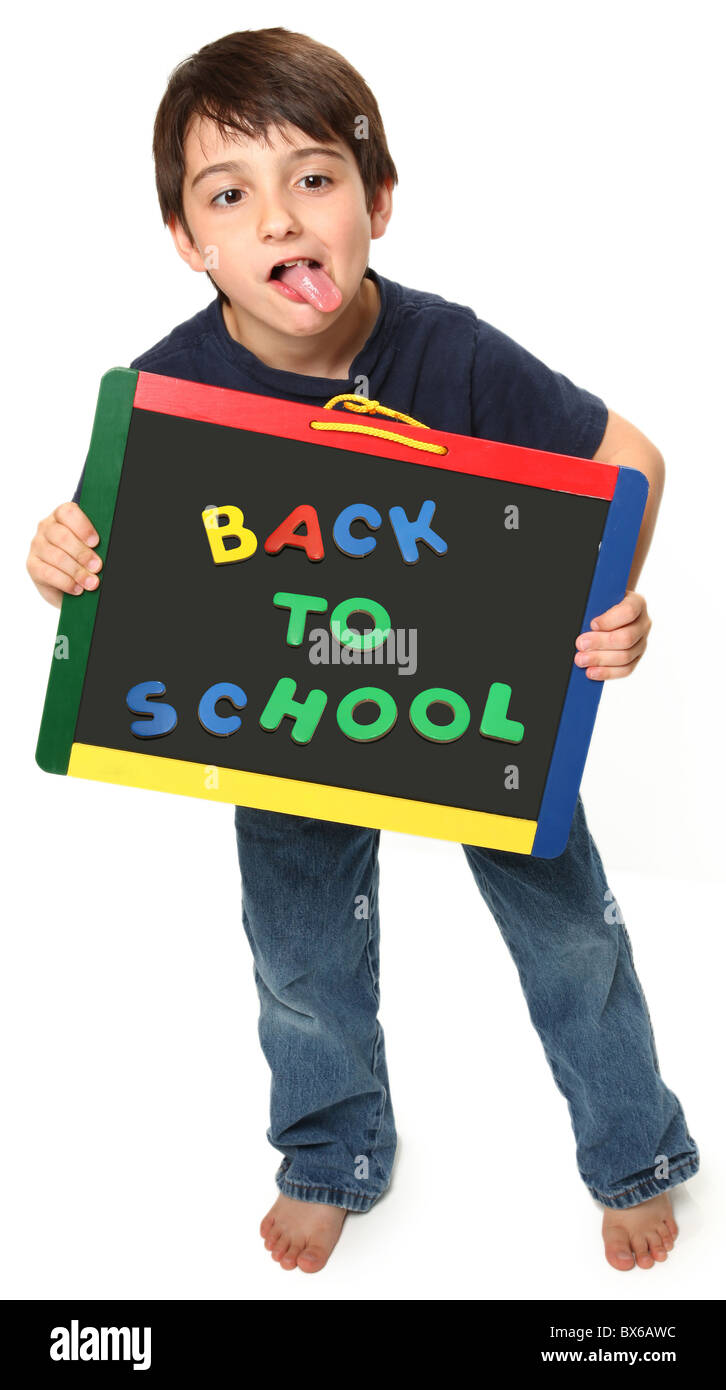 adorable seven year old boy holding back to school magnetic chalk board Stock Photo