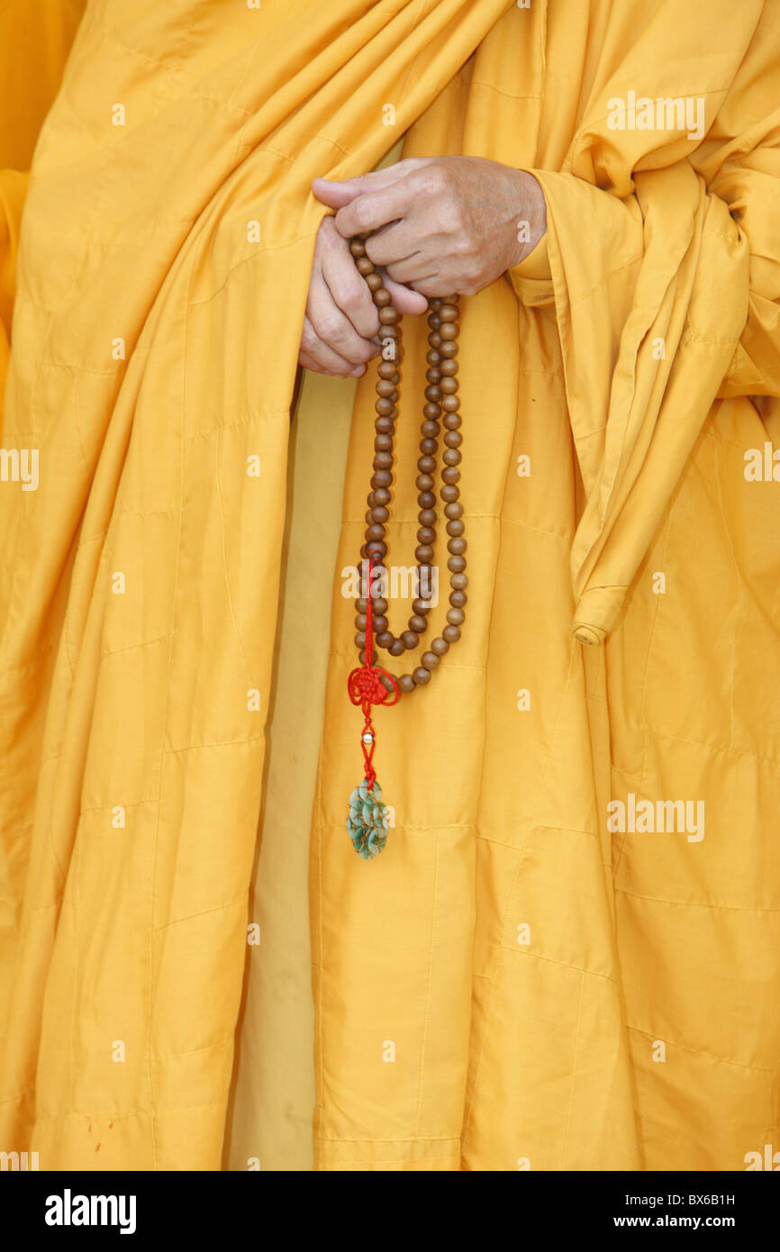A Buddhist monk holds prayer beads (Japa Mala), Bodhnath