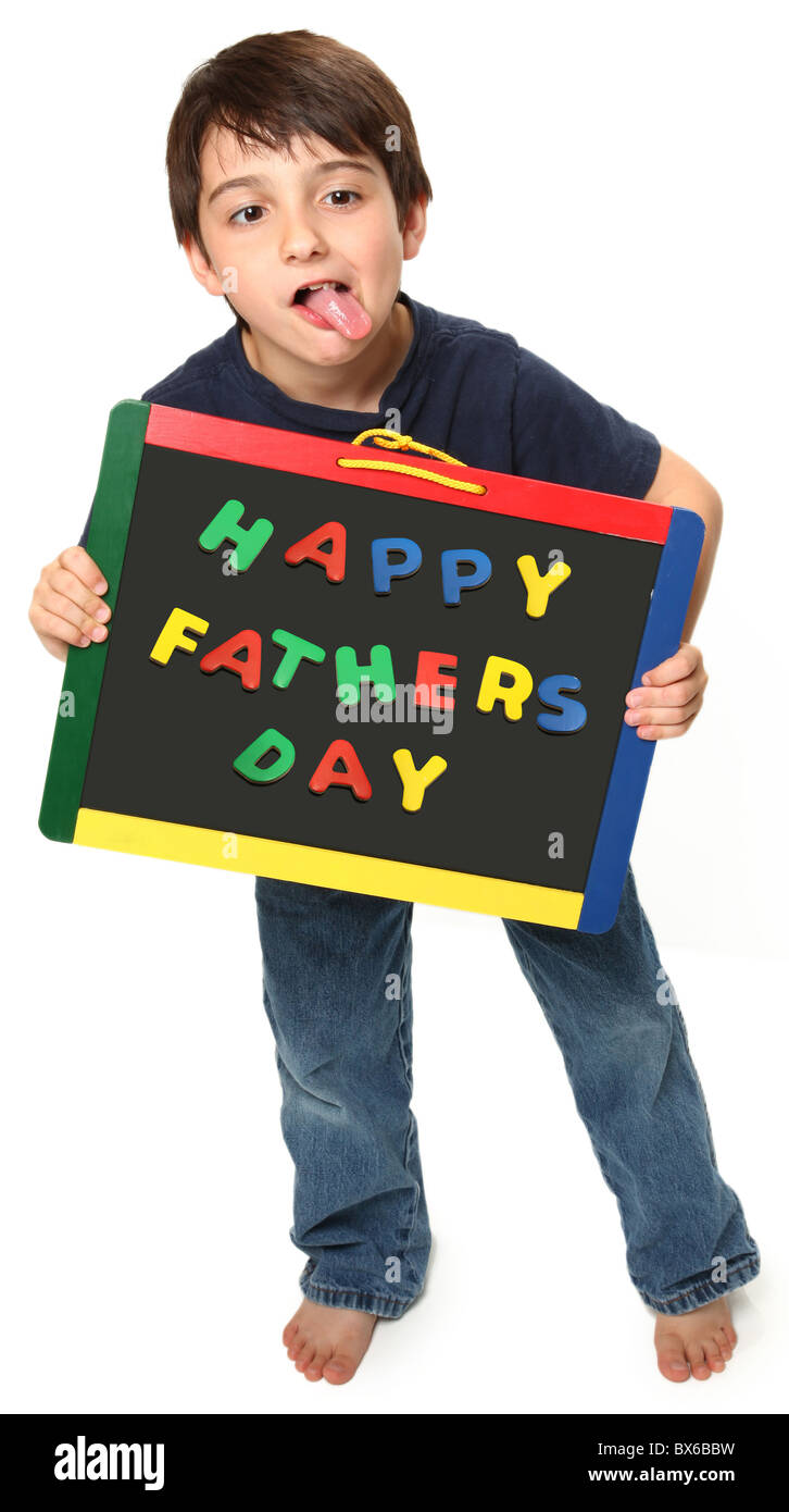 adorable seven year old boy holding happy fathers day magnetic chalk board Stock Photo