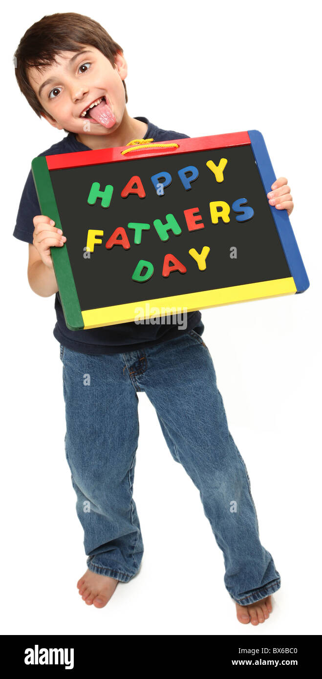 adorable seven year old boy holding happy fathers day magnetic chalk board making silly faces Stock Photo