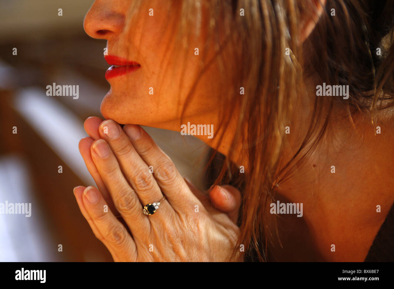 Woman praying in church, Haute Savoie, France, Europe Stock Photo