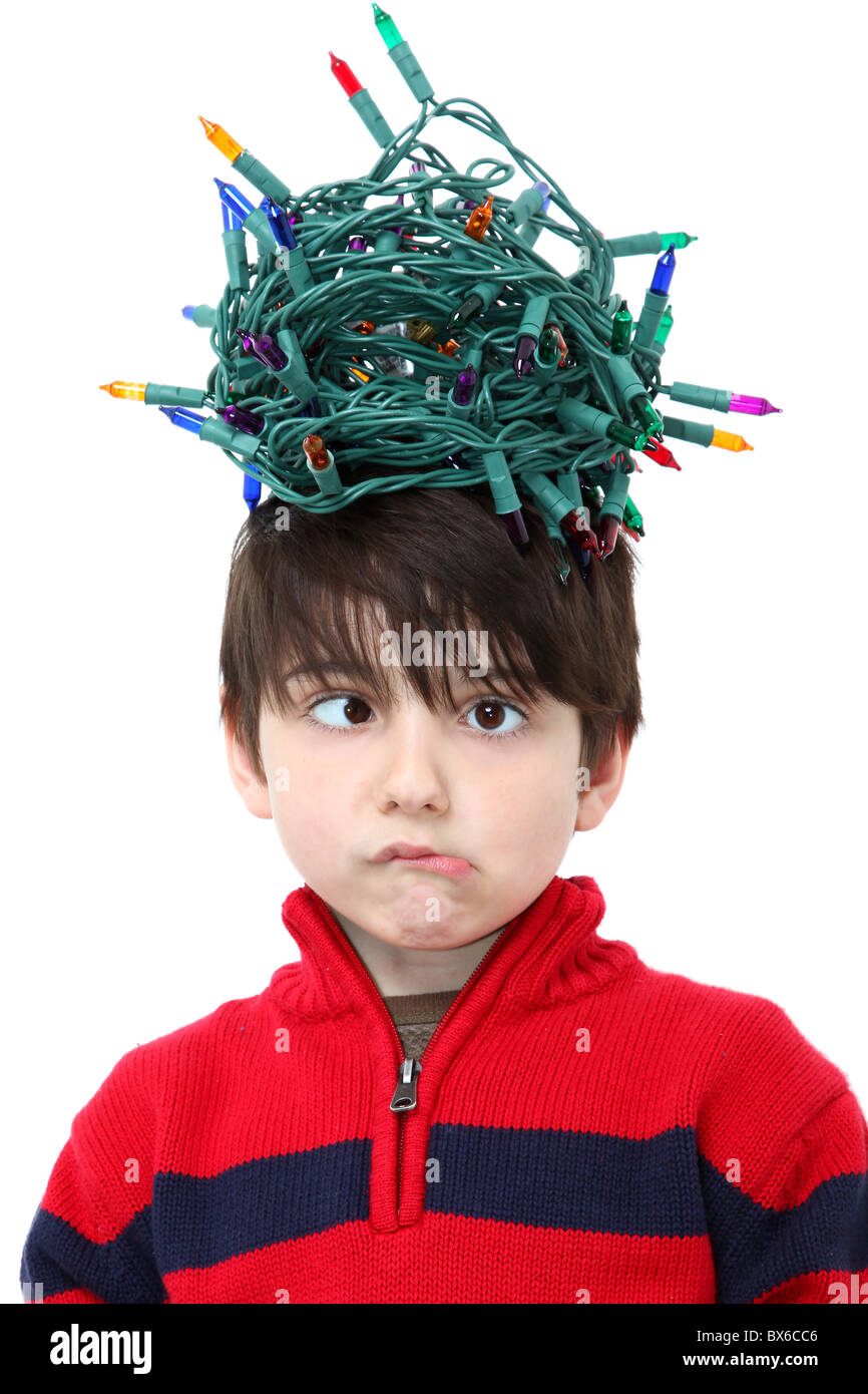 Six year old boy with tangled Christmas tree lights Stock Photo Alamy