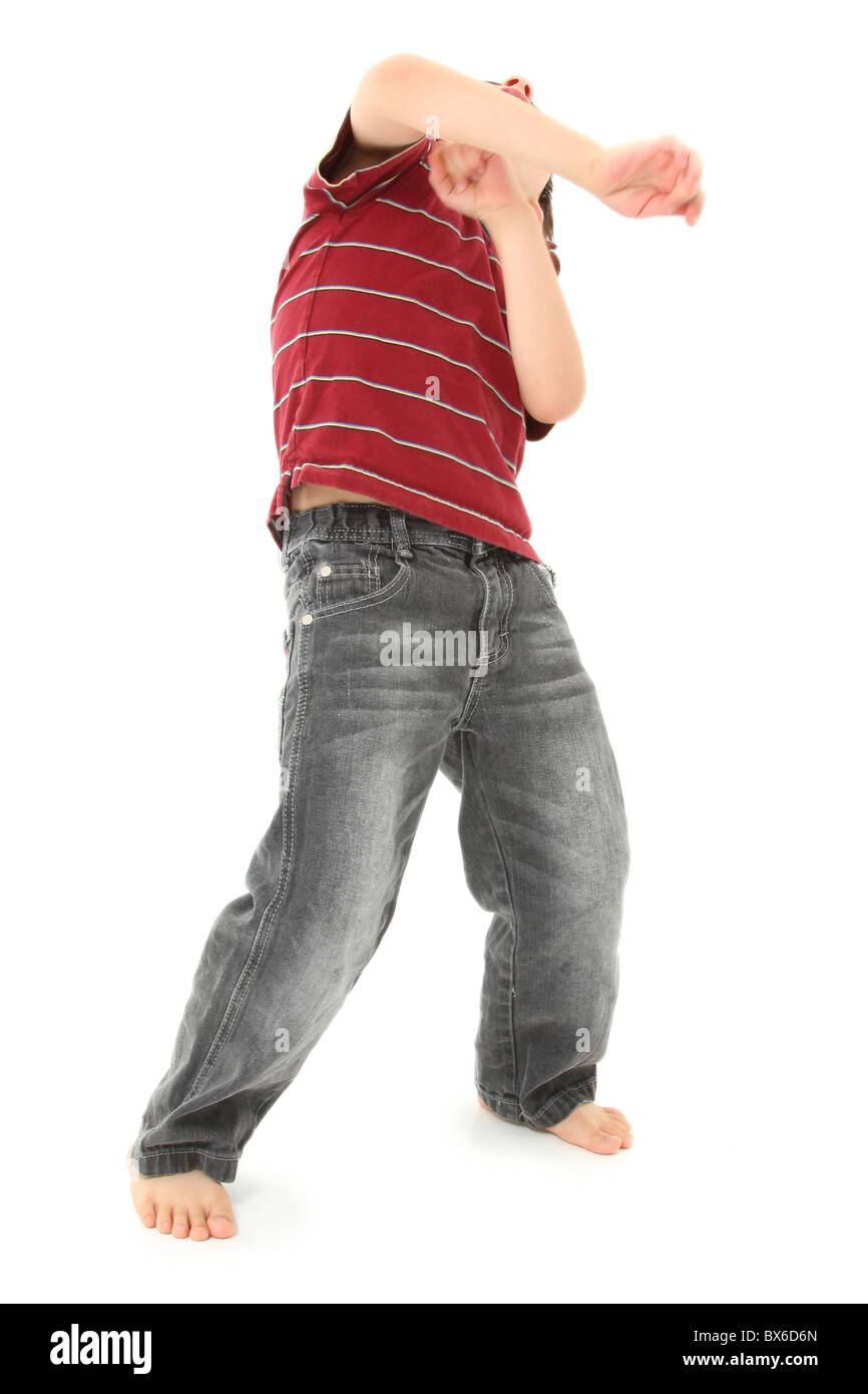 Seven year old boy dancing over white background. Stock Photo