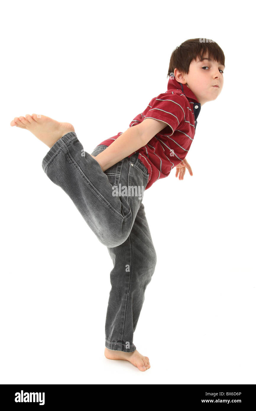 Adorable seven year old boy dancing over white. Stock Photo