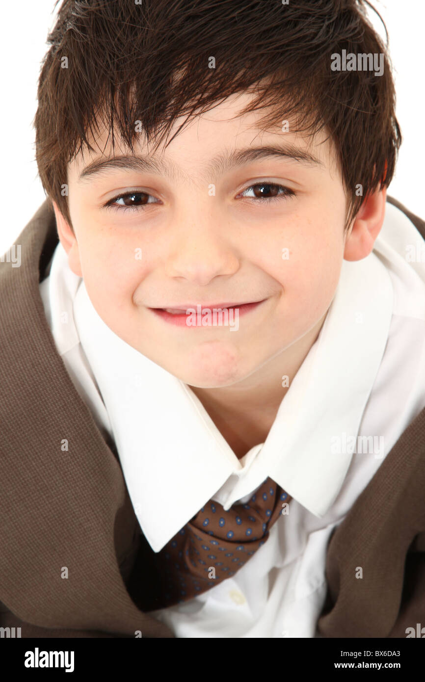 Adorable seven year old french american boy in over sized suit Stock