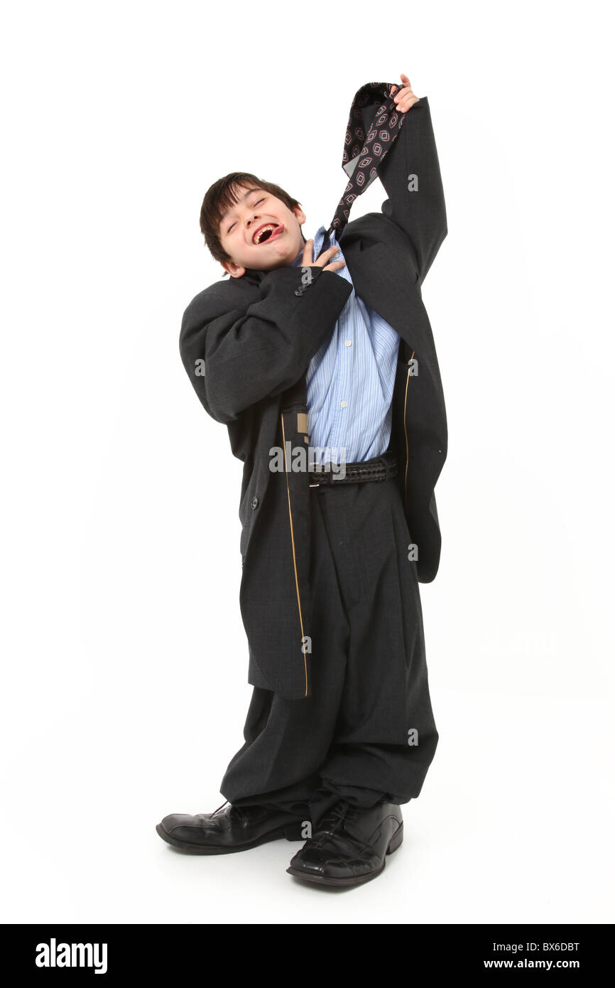 Adorable seven year old french american boy in over sized large suit