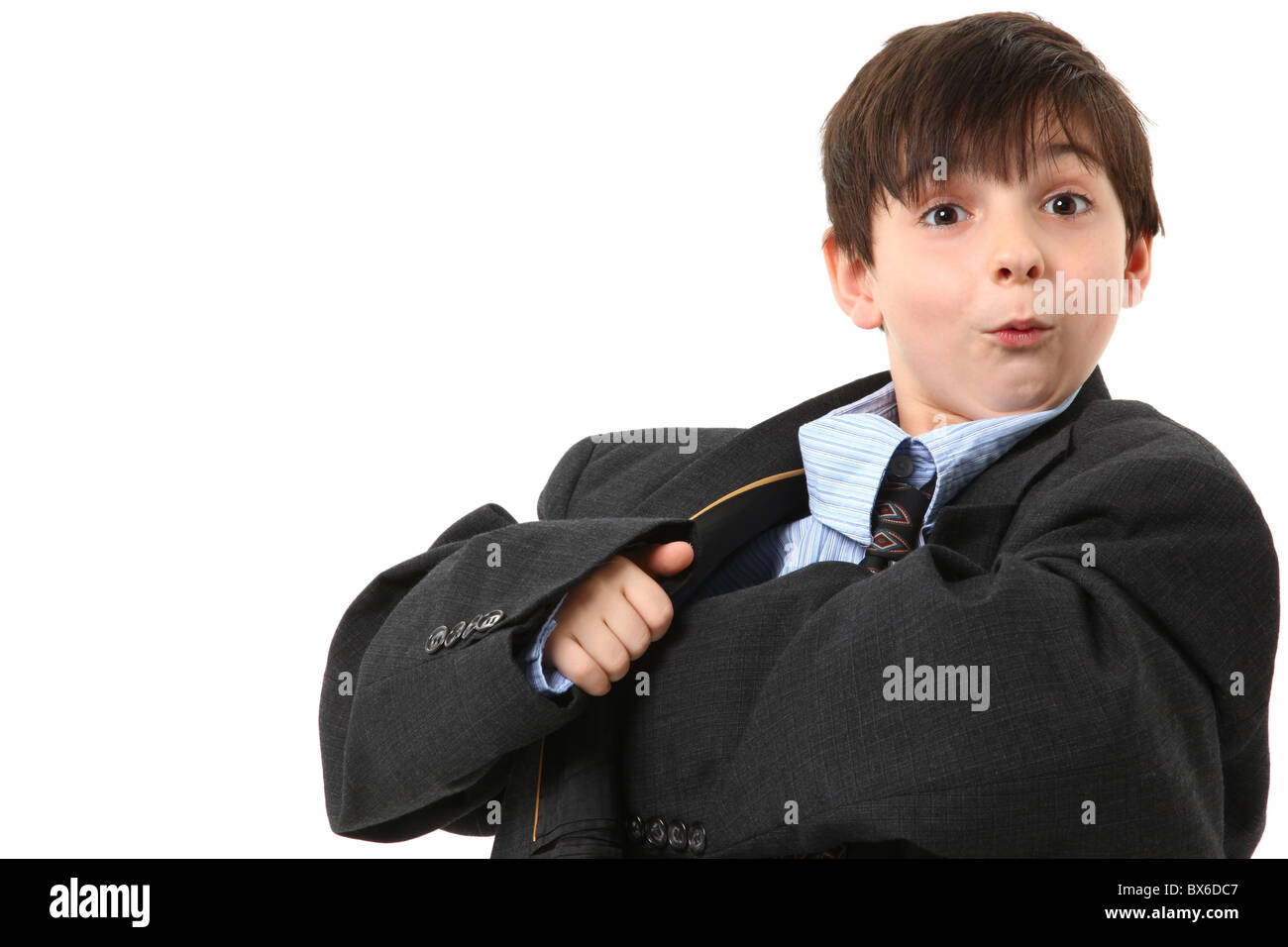 Adorable seven year old french american boy in over sized large suit