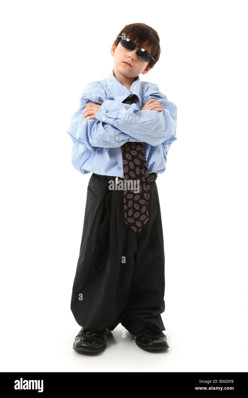 Adorable seven year old french american boy in over sized large suit