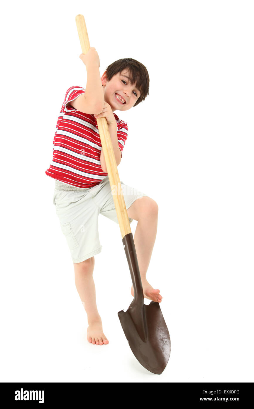Adorable seven year old french american boy with clean new unused shovel over white background. Stock Photo