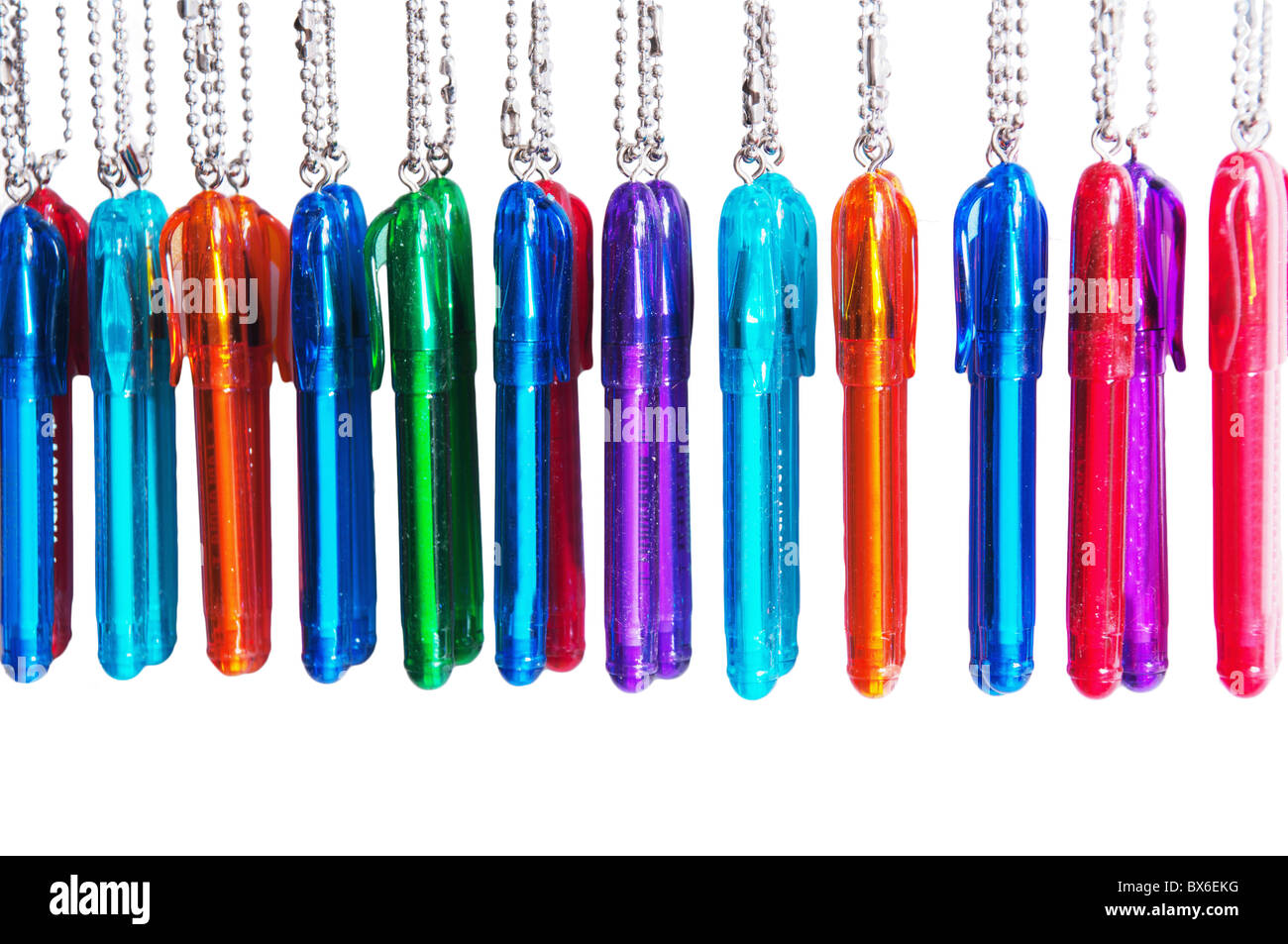Diversicolorous ball pens on chains on a white background Stock Photo