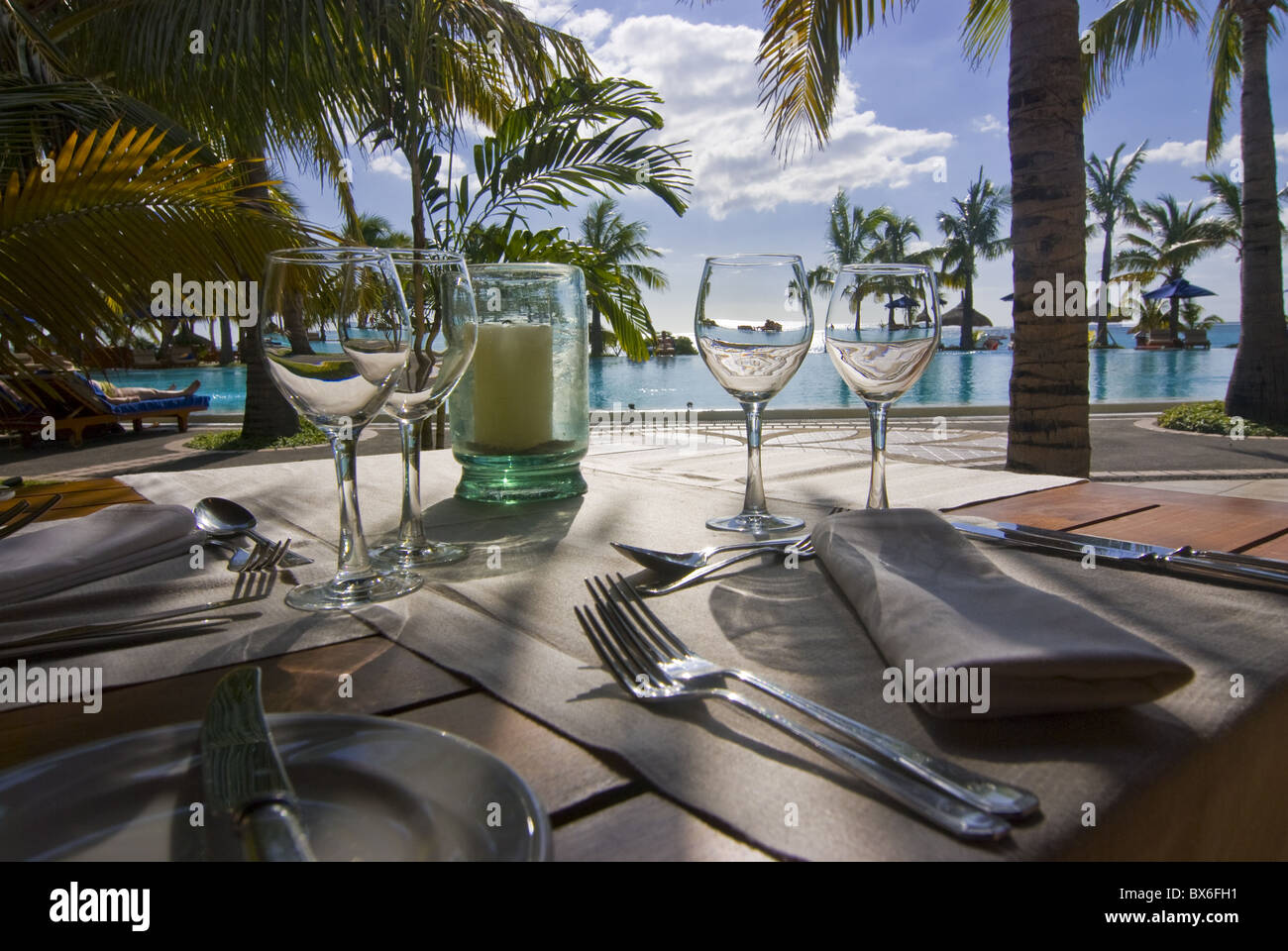 Restaurant table in front of the swimming pool of the Five star hotel Le Paradis, Mauritius, Indian Ocean, Africa Stock Photo