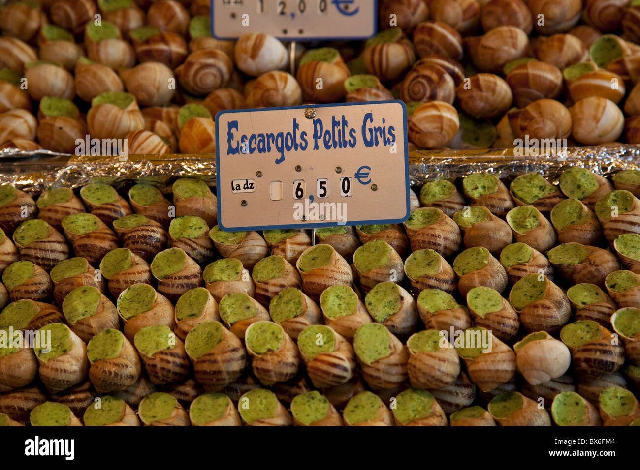 Escargot (edible land snails) for sale at local market in Paris, France, Europe Stock Photo