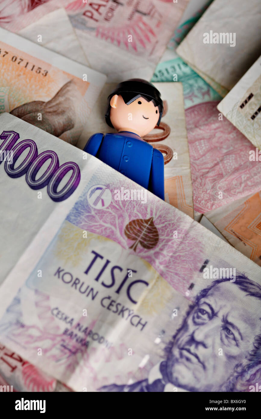 A human figure, coins, money, bank notesm Czech Crowns, sleep, financial crisis. (CTK Photo/Josef Horazny) Stock Photo