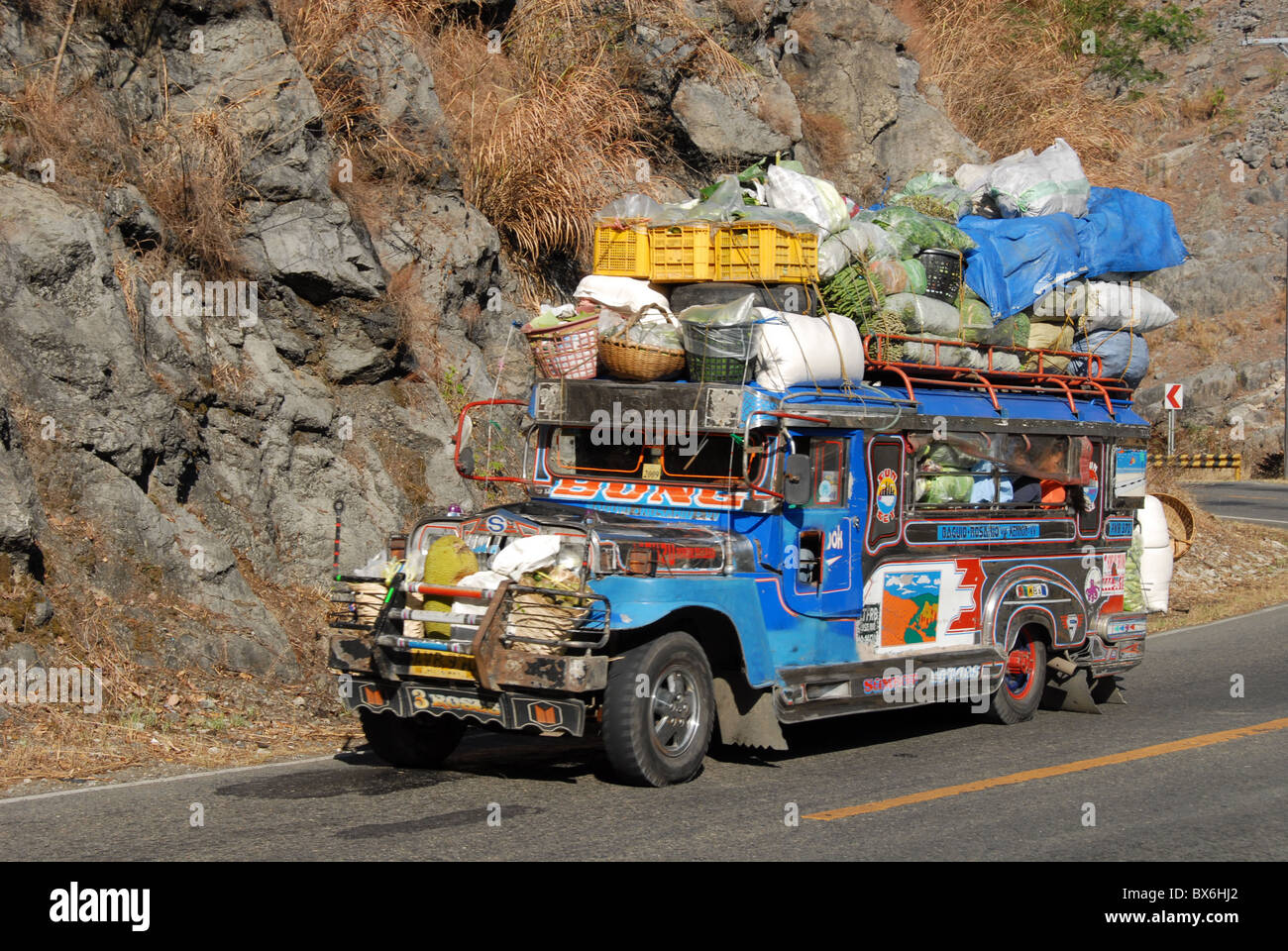 Heavily loaded jeepney, a typical local bus, on Kennon Road, Rosario-Baguio, Cordillera, Luzon, Philippines Stock Photo