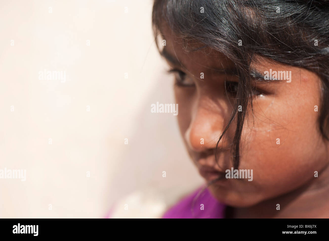 Unhappy young Indian street girl. Andhra Pradesh, India. Selective focus with copy space Stock Photo