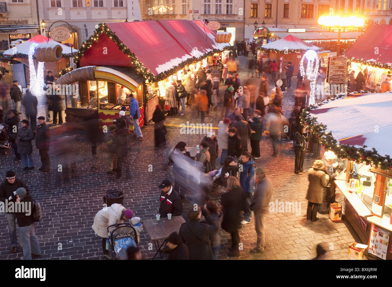 Stalls and people at Christmas Market at dusk, Old Town Square, Stare Mesto, Prague, Czech Republic, Europe Stock Photo