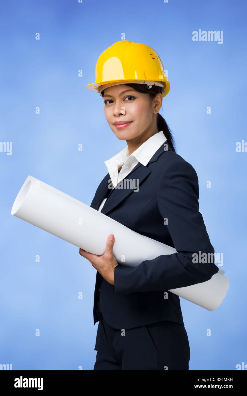 Portrait of pretty female with paper in hands and helmet on head ...