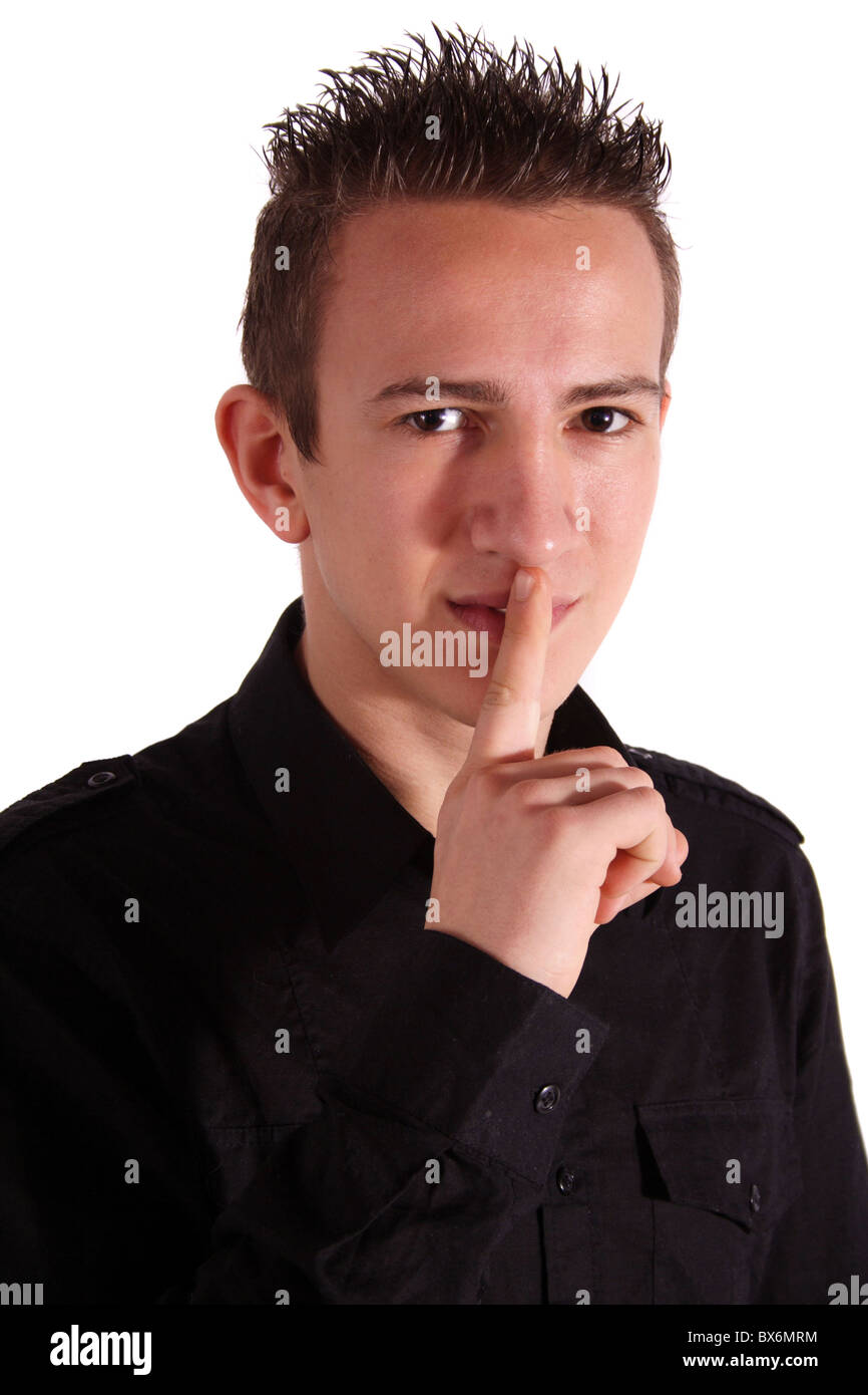A young handsome man asks for silence. All isolated on white background. Stock Photo