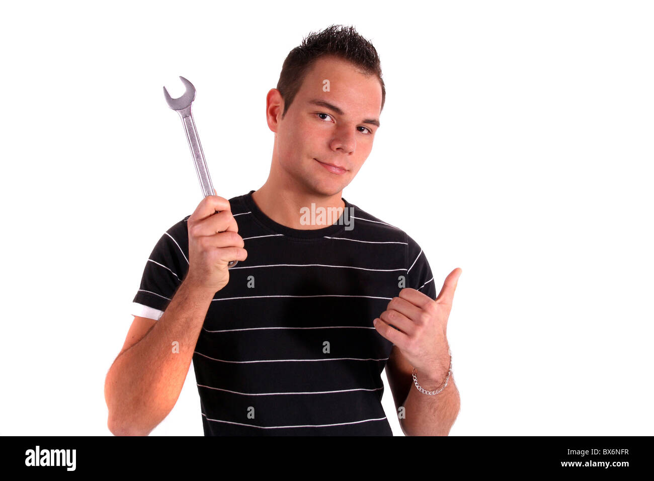 A young handsome apprentice satisfied with his work. All isolated on white background. Stock Photo