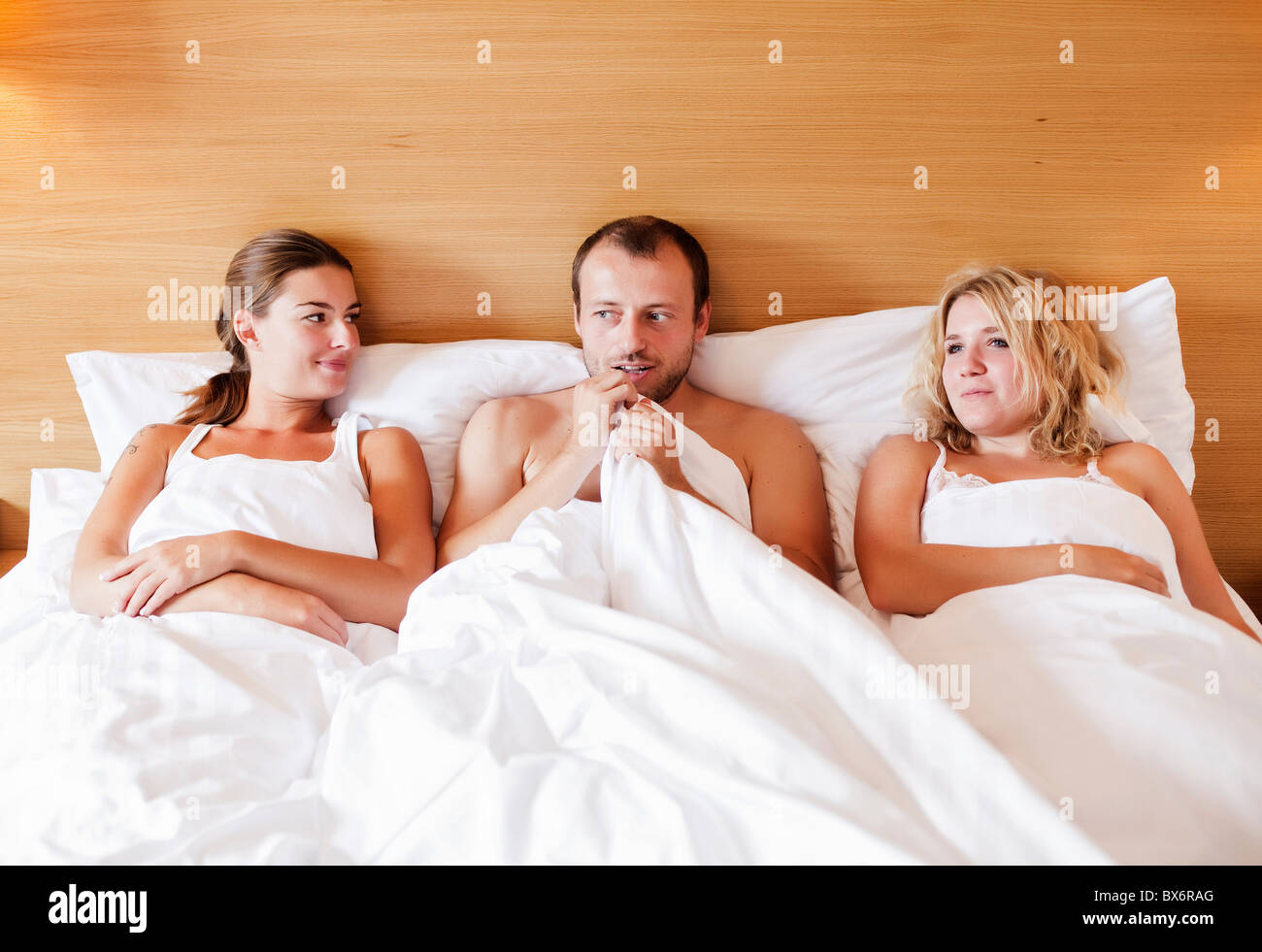 marriage, marital triangle, man, woman, women, bed, sex Stock Photo photo