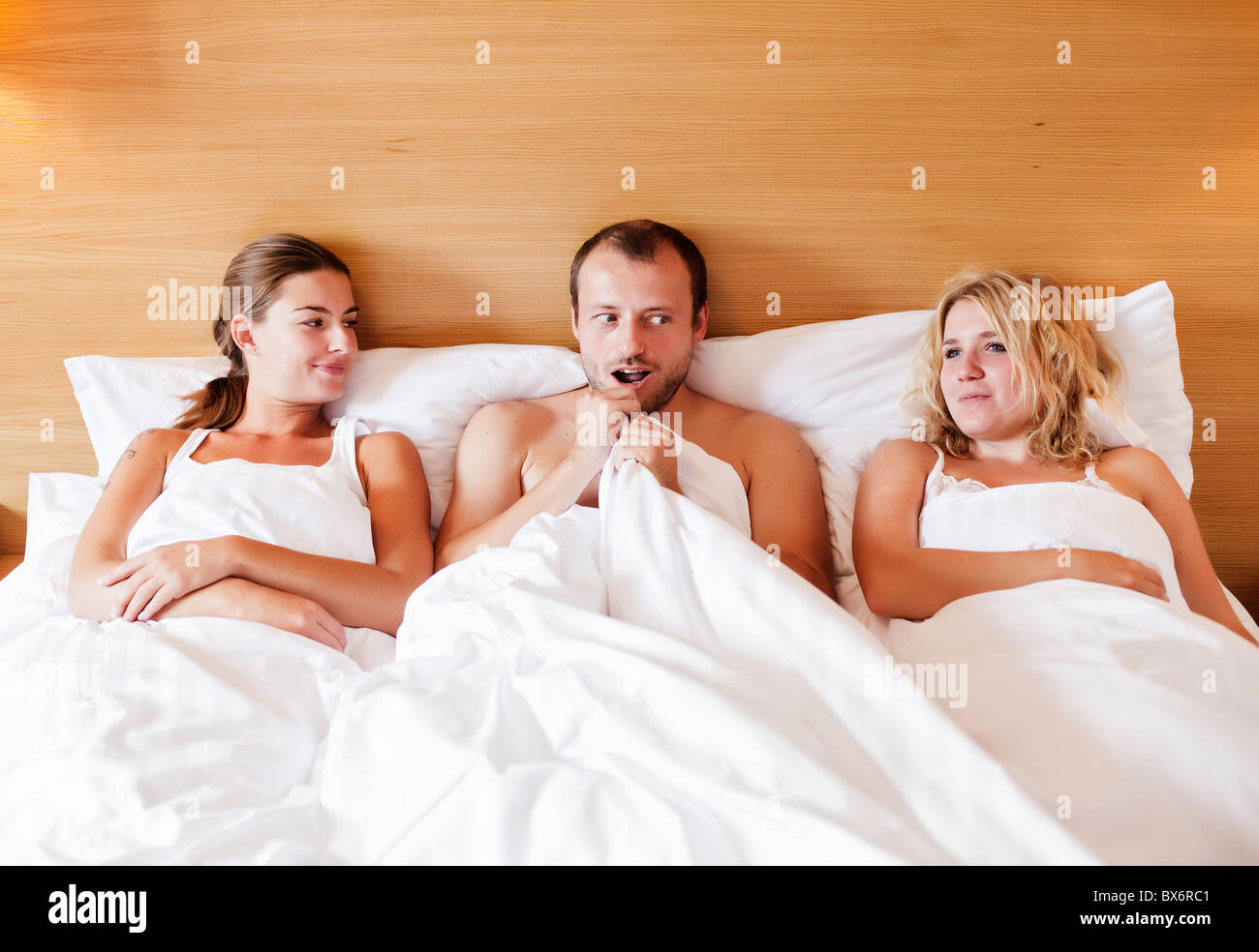 marriage, marital triangle, man, woman, women, bed, sex Stock Photo