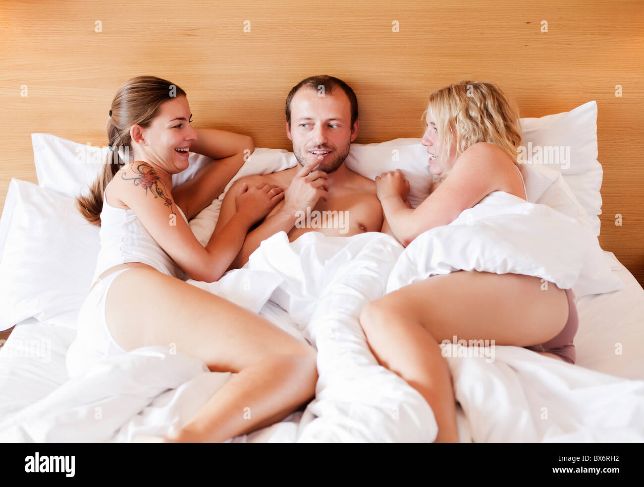 marriage, marital triangle, man, woman, women, bed, sex Stock Photo